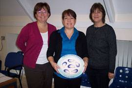 Vicky, Diane and Janet standing in a line, with the award beign held in the centre of the image.