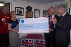 Geoffrey Wilkinson and Gillian Butler standing on either side of a giant cheque.